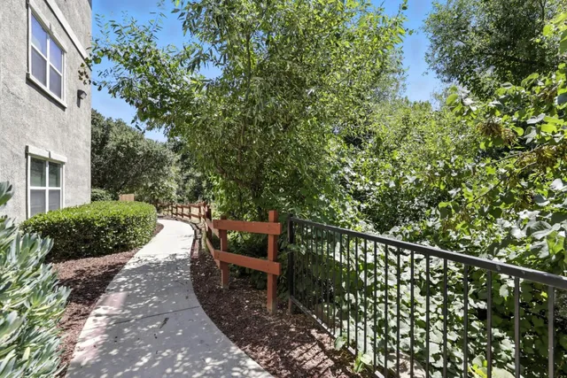 a front view of a house with plants