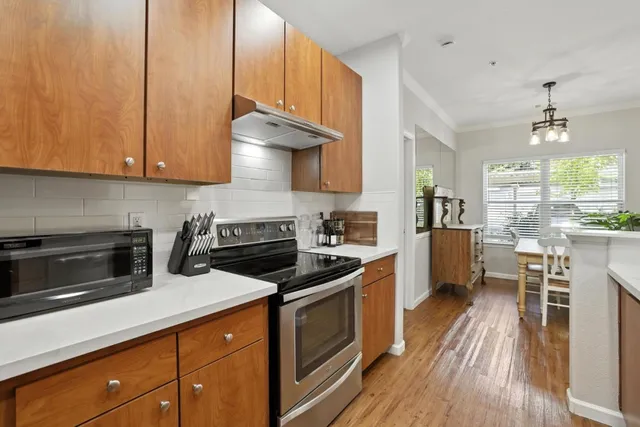 a kitchen with a sink a stove and cabinets