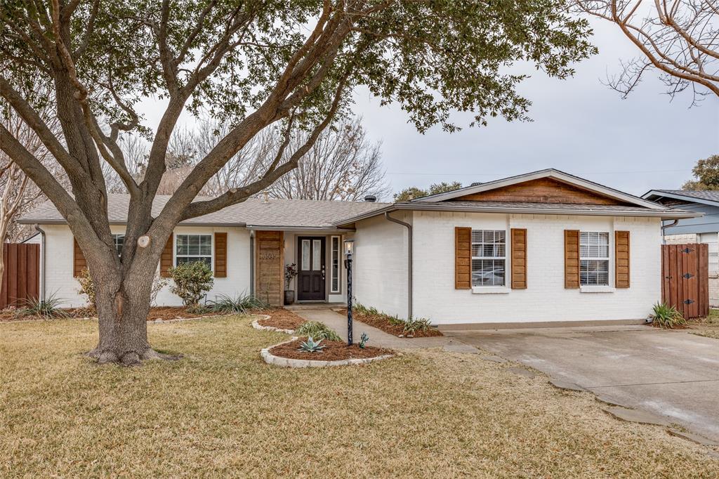 8535 Strathmore Drive Dallas, TX 75238 - Photo 1 of 23 a front view of a house with a yard and large tree