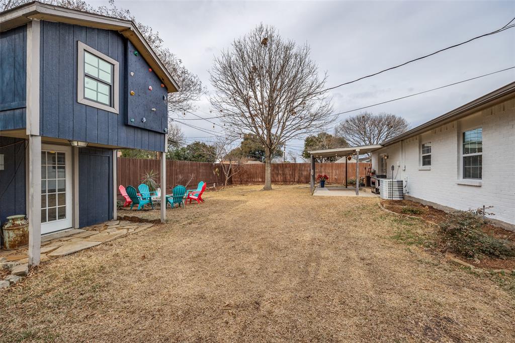 8535 Strathmore Drive Dallas, TX 75238 - Photo 16 of 23 a view of a house with a backyard