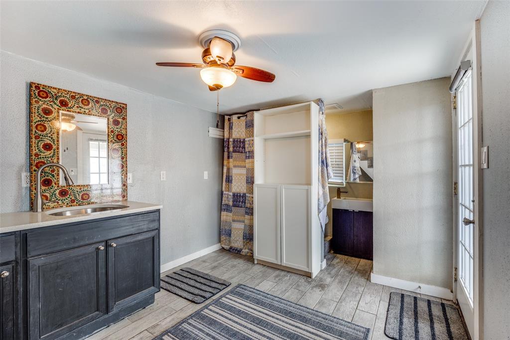 8535 Strathmore Drive Dallas, TX 75238 - Photo 17 of 23 a view of bathroom with a sink and a mirror