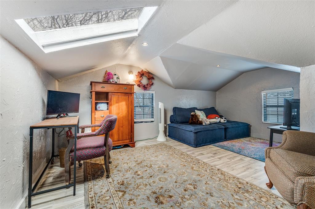 8535 Strathmore Drive Dallas, TX 75238 - Photo 19 of 23 a bed room with a bed and a chair
