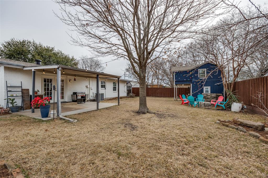 8535 Strathmore Drive Dallas, TX 75238 - Photo 21 of 23 a view of a house with a patio and a yard