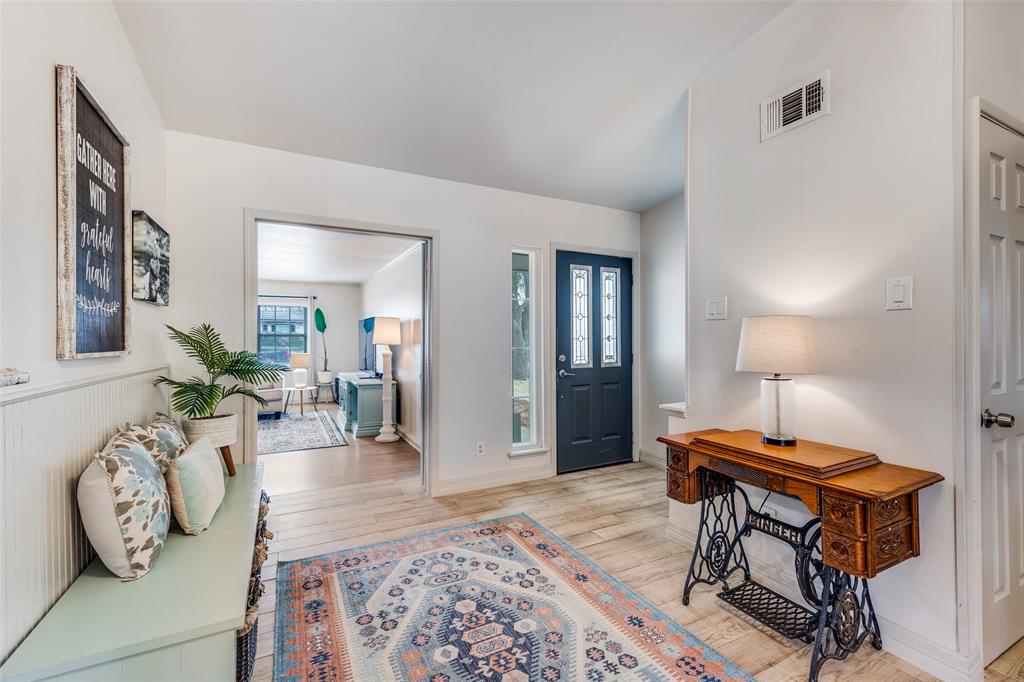 8535 Strathmore Drive Dallas, TX 75238 - Photo 4 of 23 a living room with furniture and wooden floor