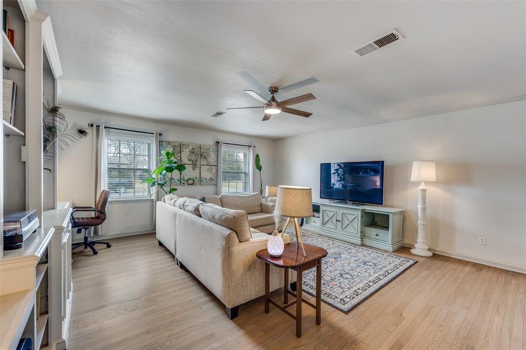 8535 Strathmore Drive Dallas, TX 75238 - Photo 5 of 23 a living room with furniture and a wooden floor