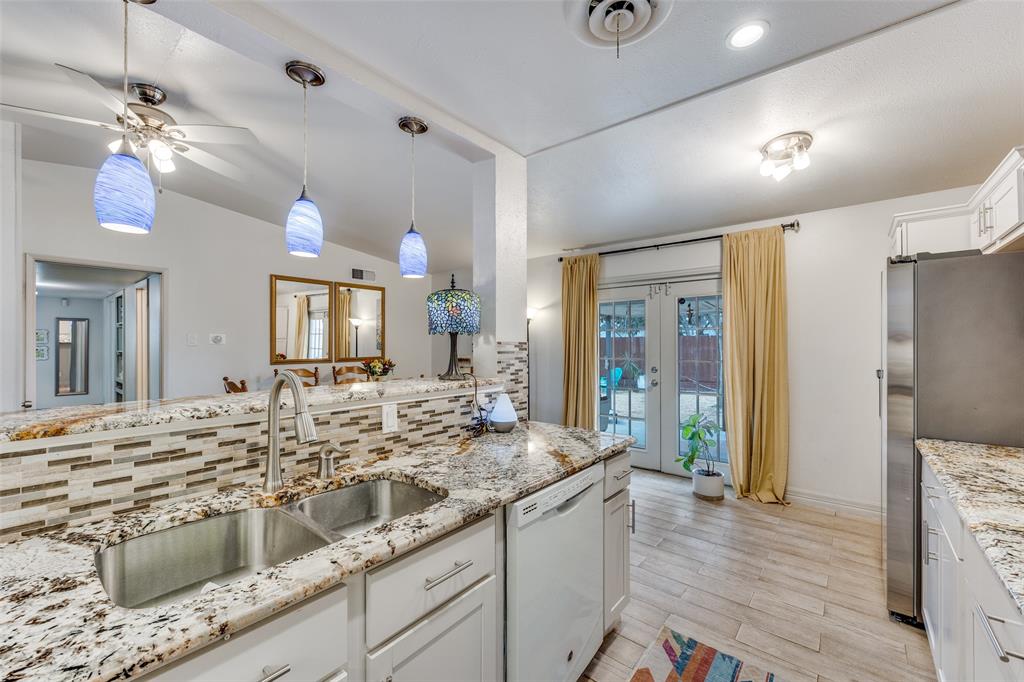 8535 Strathmore Drive Dallas, TX 75238 - Photo 9 of 23 a bathroom with a sink double vanity granite and a shower