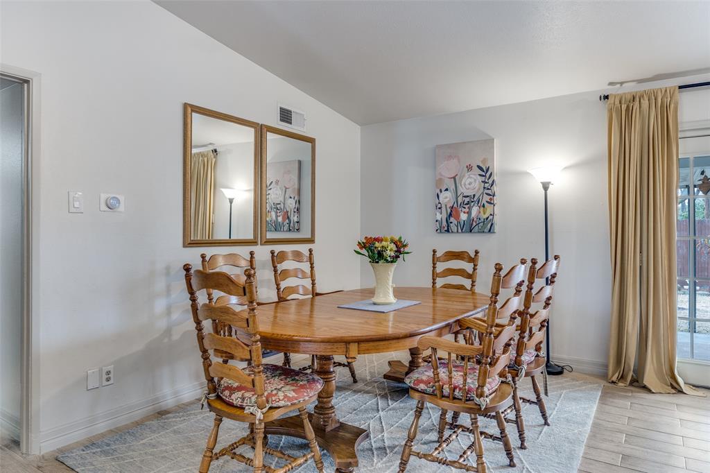 8535 Strathmore Drive Dallas, TX 75238 - Photo 10 of 23 a view of a dining room with furniture and wooden floor