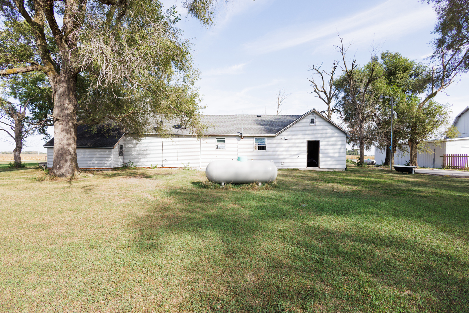 2060 West 5000S Road Chebanse, IL 60922 - Photo 28 of 54 a backyard of a house with barbeque oven fire pit table and chairs