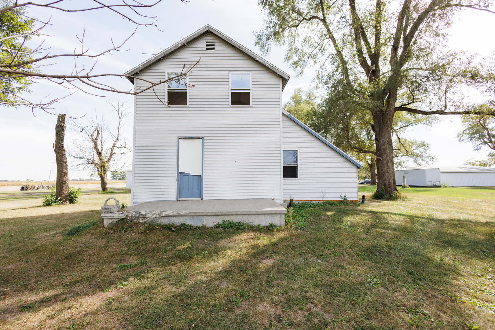 2060 West 5000S Road Chebanse, IL 60922 - Photo 33 of 54 a white house that has a tree in front of it