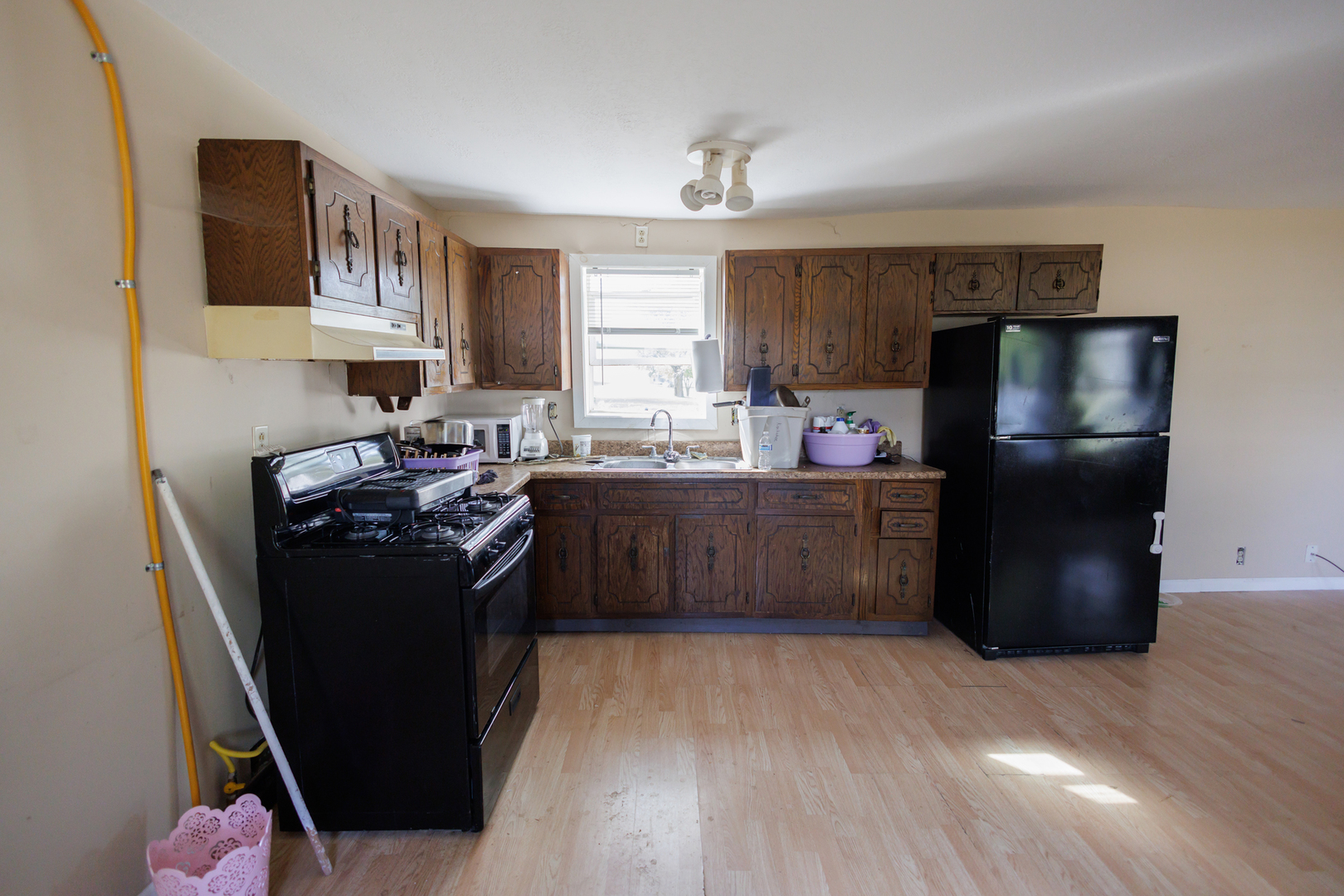 2060 West 5000S Road Chebanse, IL 60922 - Photo 10 of 54 a kitchen with stainless steel appliances granite countertop a refrigerator a stove a sink dishwasher and wooden cabinets with wooden floor