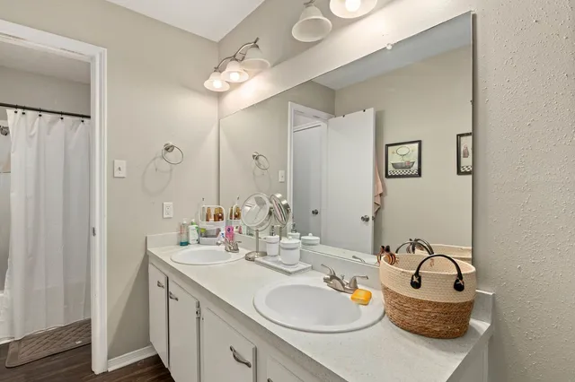 a bathroom with 2 sink and a mirror