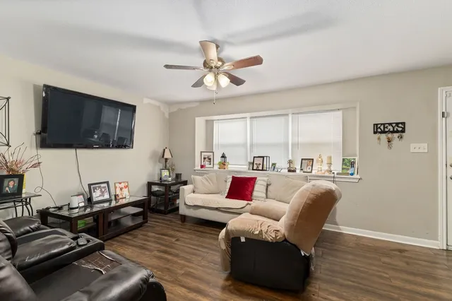a living room with furniture fireplace and a flat screen tv