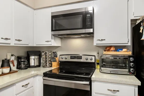 a kitchen with appliances and cabinets