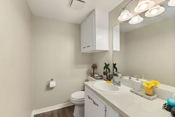 a bathroom with a sink a toilet and a mirror