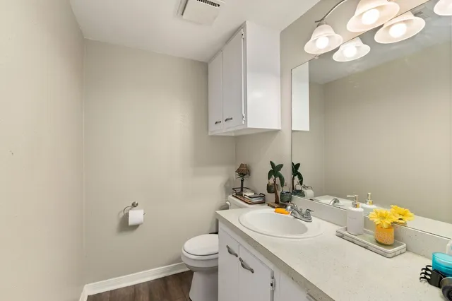 a bathroom with a sink a toilet and a mirror