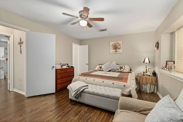 a bedroom with furniture and wooden floor