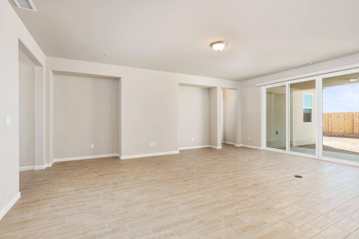 952 Pinnacle Drive Madera, CA 93636 - Photo 11 of 32 a view of an empty room with wooden floor