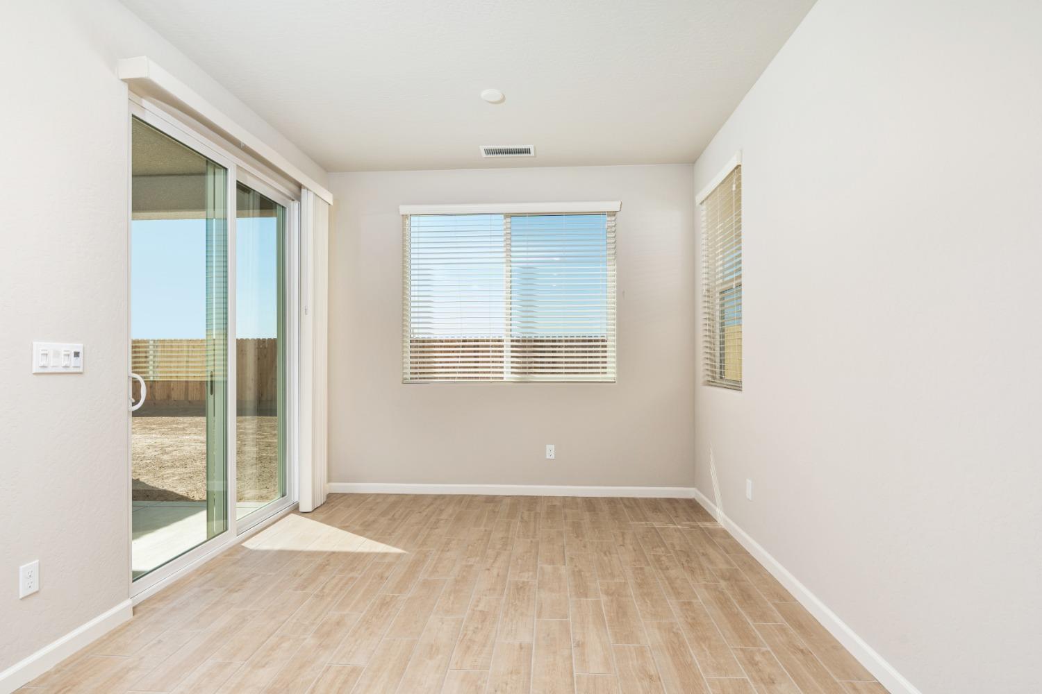 952 Pinnacle Drive Madera, CA 93636 - Photo 18 of 32 a view of a room with wooden floor and windows