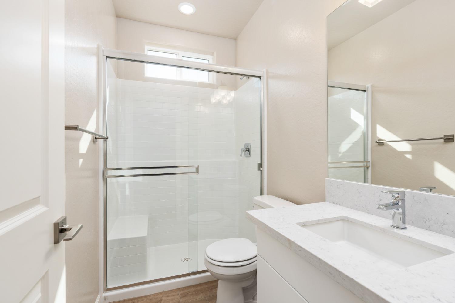 952 Pinnacle Drive Madera, CA 93636 - Photo 8 of 32 a bathroom with a granite countertop sink toilet and shower