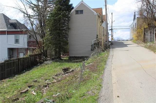 a backyard of a house with yard and outdoor seating