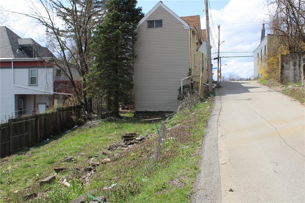 2206 Elsie Street Pittsburgh, PA 15210 - Photo 5 of 11 a backyard of a house with yard and outdoor seating