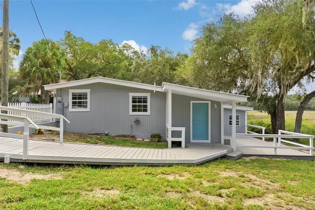 a view of a house with swimming pool and porch