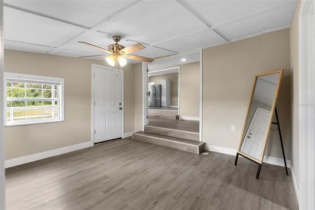 a view of an entryway with wooden floor