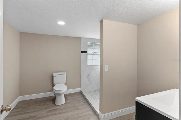a view of bathroom with a sink and mirror