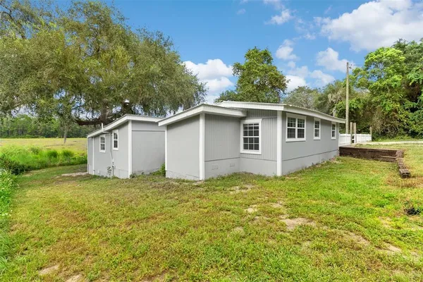 a backyard of a house with plants and lake view