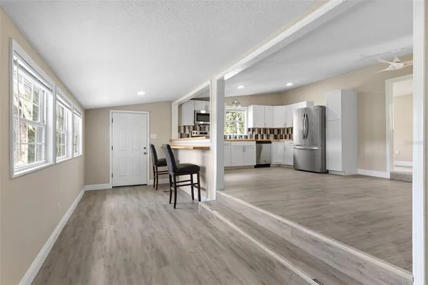 a view of a kitchen with a refrigerator and a window