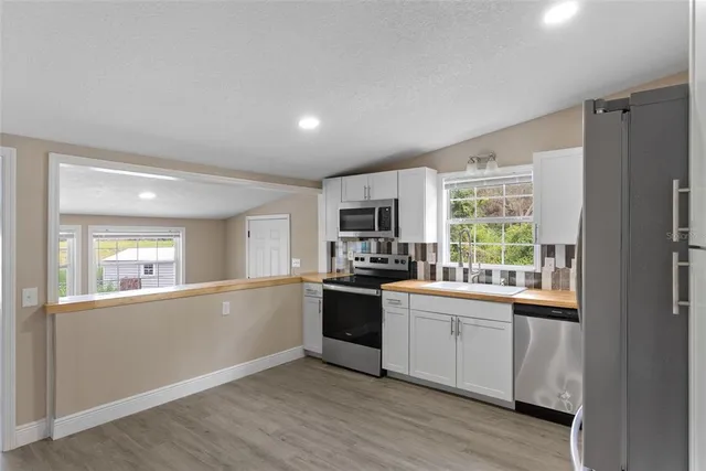 a kitchen with a sink and wooden floor