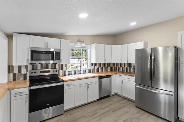 a kitchen with a sink stainless steel appliances and cabinets
