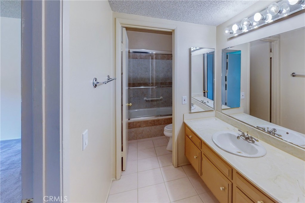 6600 Warner Avenue, Unit 88 Huntington Beach, CA 92647 - Photo 5 of 25 a bathroom with a sink a toilet and shower