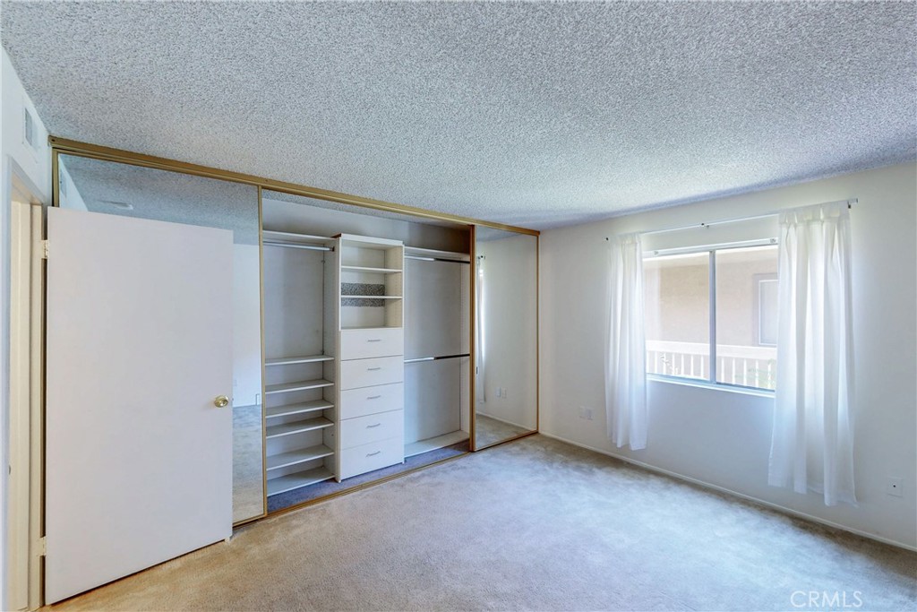 6600 Warner Avenue, Unit 88 Huntington Beach, CA 92647 - Photo 6 of 25 an empty room with closet and windows
