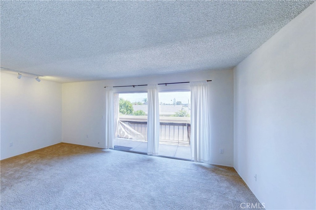 6600 Warner Avenue, Unit 88 Huntington Beach, CA 92647 - Photo 8 of 25 a view of an empty room with a window