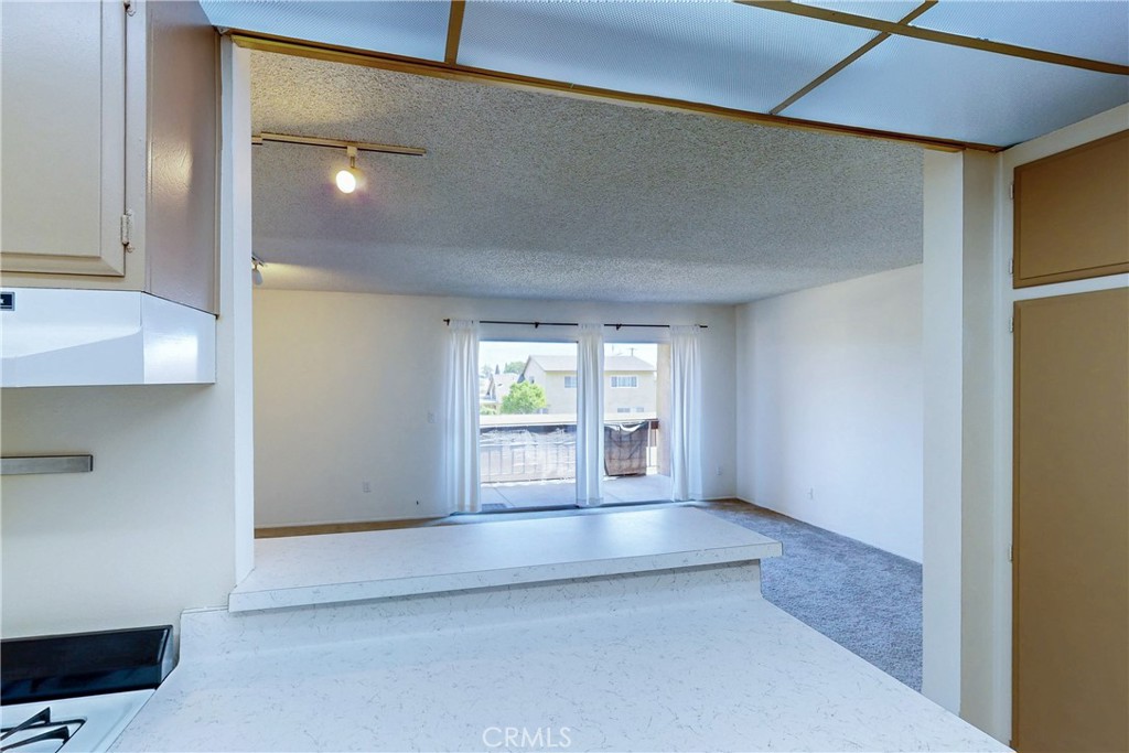 6600 Warner Avenue, Unit 88 Huntington Beach, CA 92647 - Photo 10 of 25 a view of an empty room with wooden floor and a window