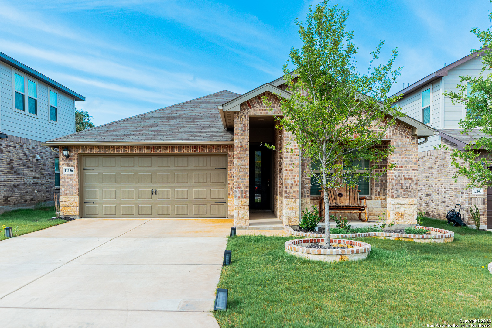 a front view of house with yard and green space