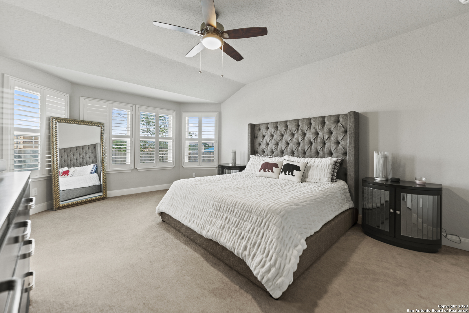 12136 Icon Ridge San Antonio, TX 78253 - Photo 13 of 26 a spacious bedroom with a bed couch and a large window