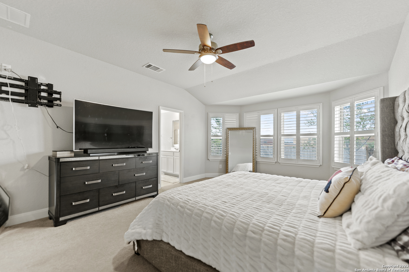 12136 Icon Ridge San Antonio, TX 78253 - Photo 15 of 26 a bedroom with a bed and a flat screen tv