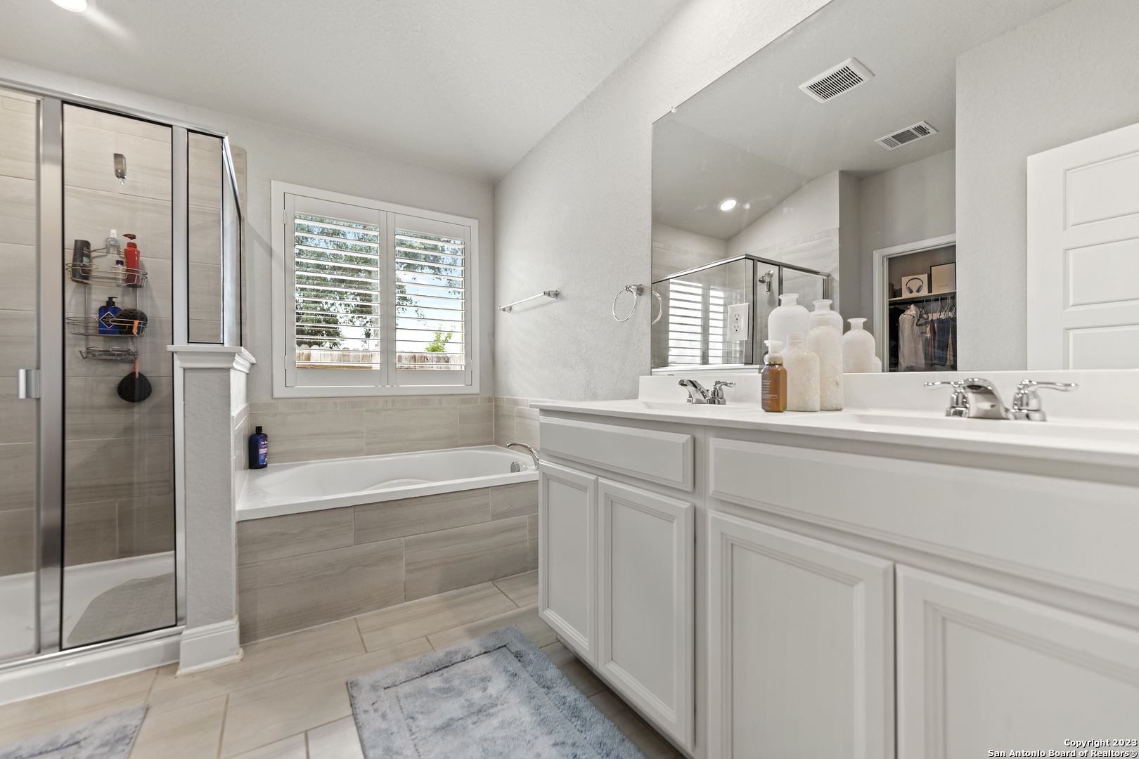 12136 Icon Ridge San Antonio, TX 78253 - Photo 16 of 26 a bathroom with a tub sink and mirror