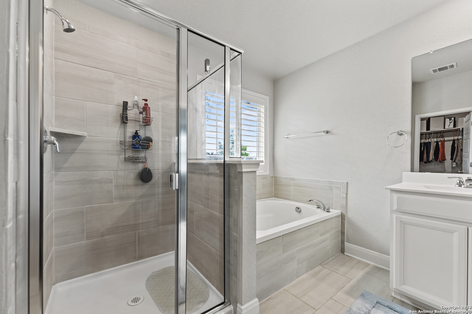 12136 Icon Ridge San Antonio, TX 78253 - Photo 17 of 26 a bathroom with a bathtub and a shower