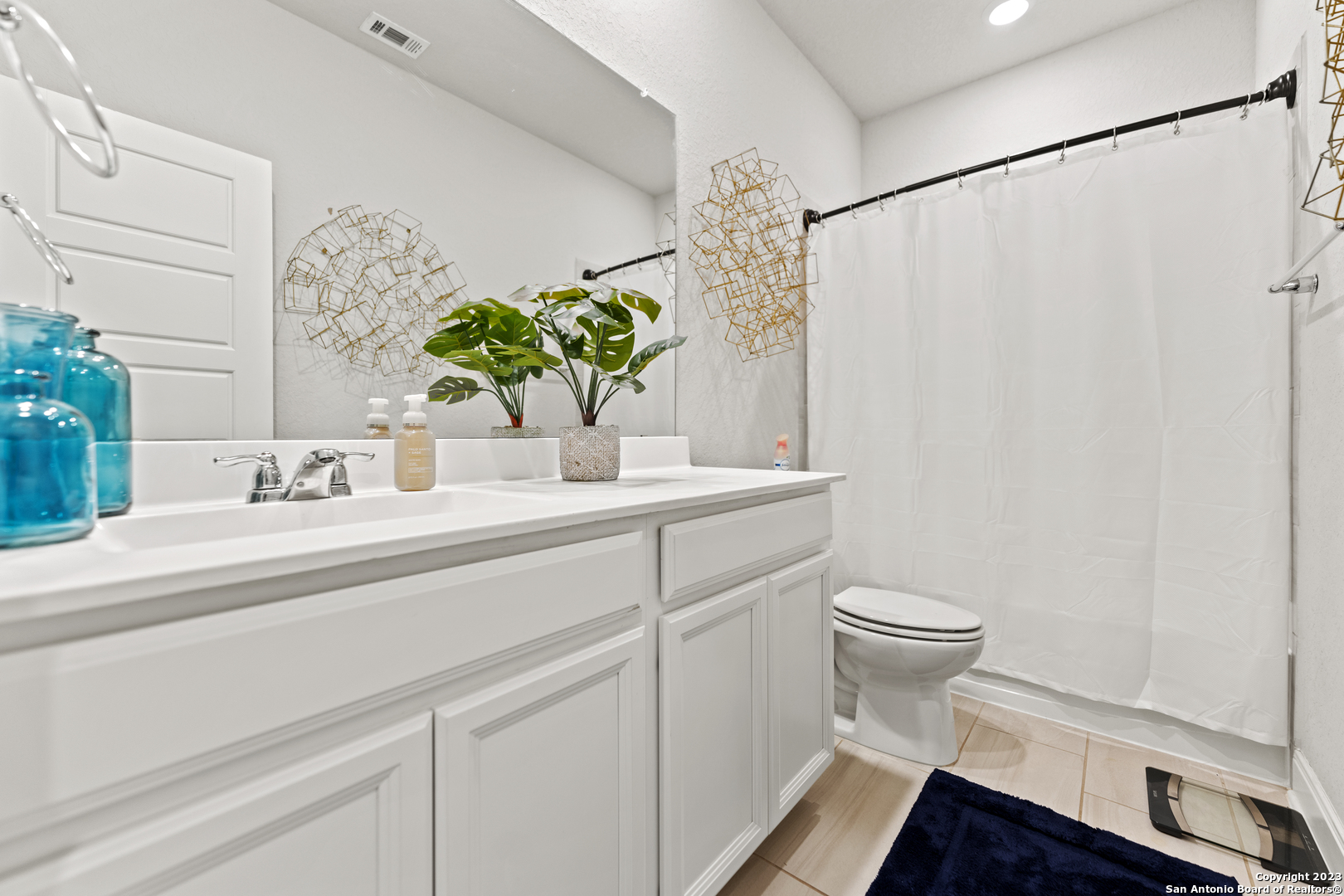12136 Icon Ridge San Antonio, TX 78253 - Photo 20 of 26 a bathroom with a sink a toilet and a mirror