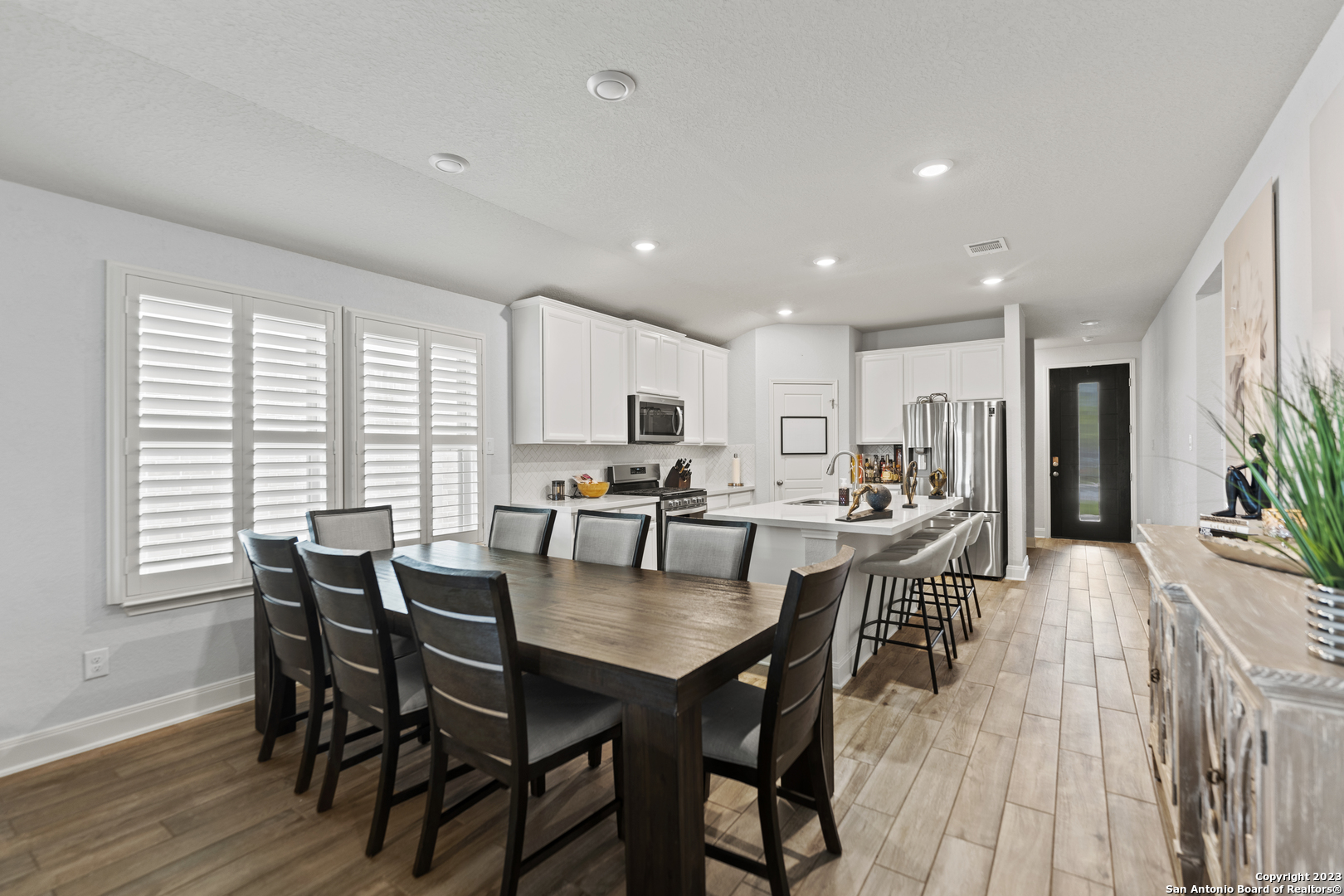12136 Icon Ridge San Antonio, TX 78253 - Photo 7 of 26 a view of a dining room with furniture window and wooden floor