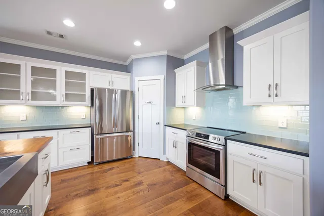 a kitchen with stainless steel appliances granite countertop a stove and a refrigerator