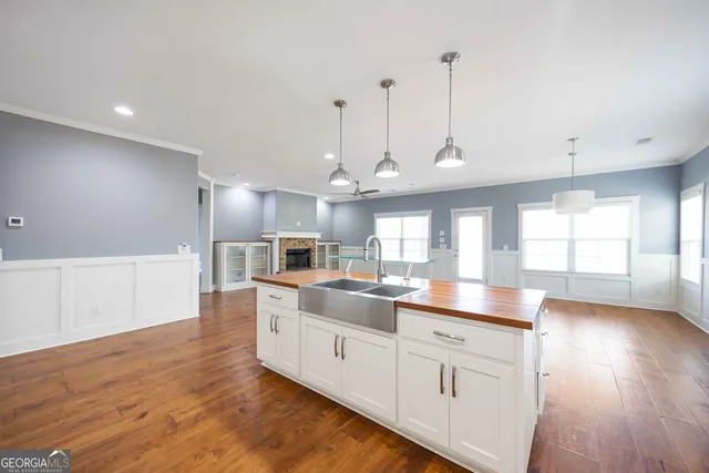 a kitchen with counter top space and wooden floor