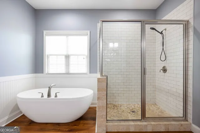 a bathroom with a bathtub and shower