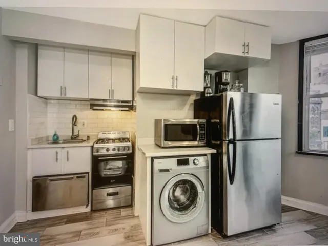 a kitchen with stainless steel appliances granite countertop a refrigerator sink and stove