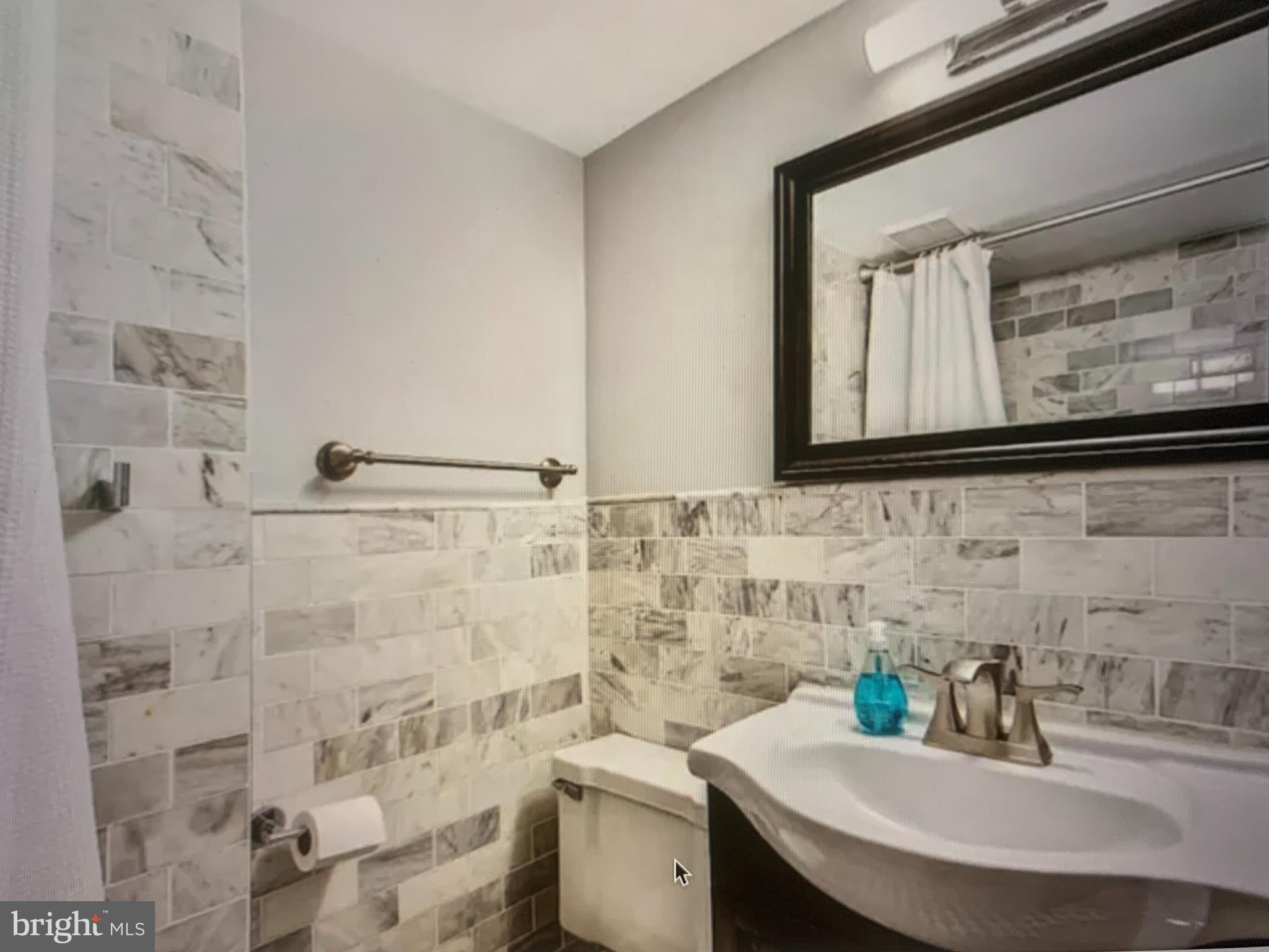 2135 Walnut Street, Unit 901 Philadelphia, PA 19103 - Photo 8 of 8 a bathroom with a sink and a toilet