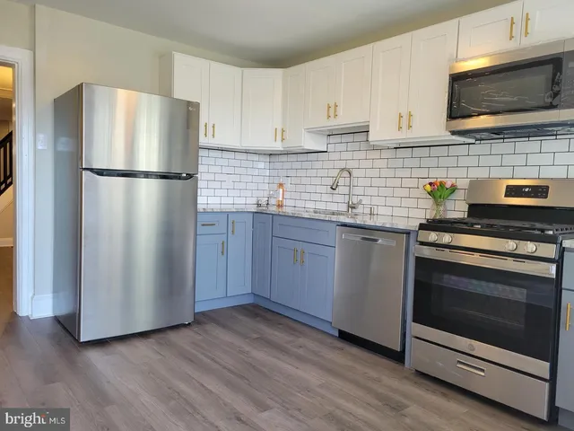 a kitchen with stainless steel appliances a refrigerator stove and microwave
