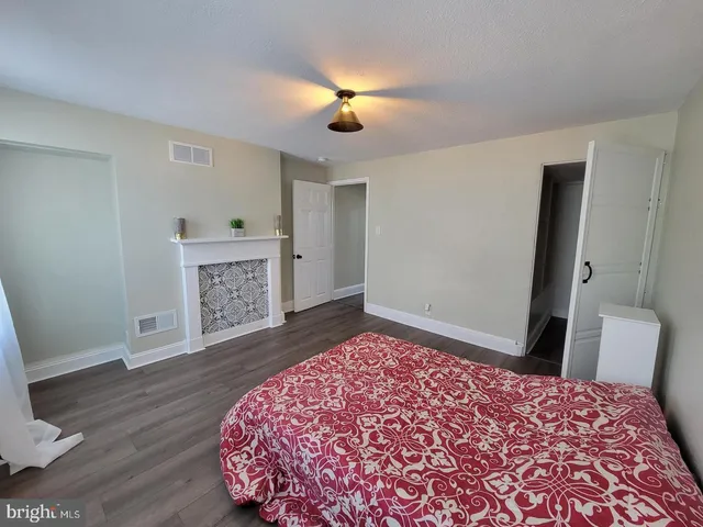 a bedroom with a bed and a lamp